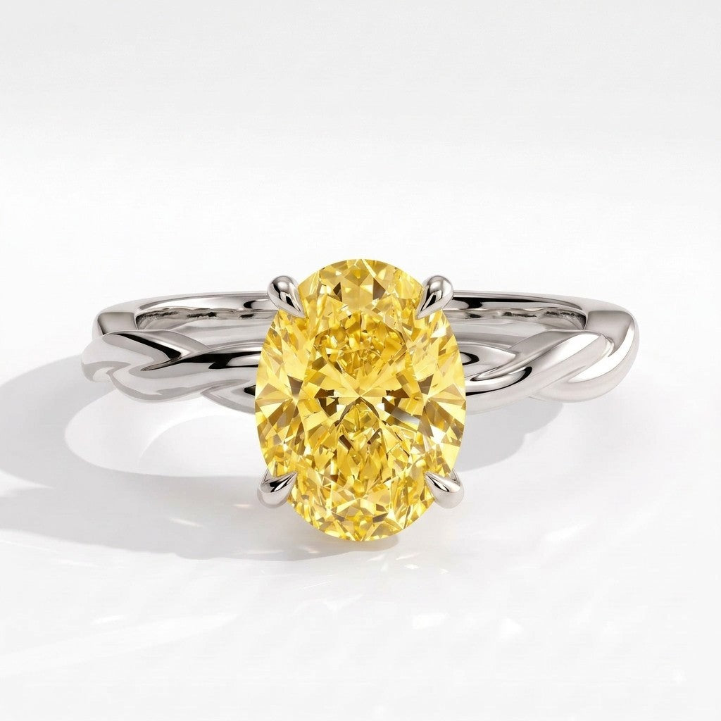 Fancy Vivid Yellow oval lab-grown diamond solitaire engagement ring with twisted band in 950 platinum, front view 
