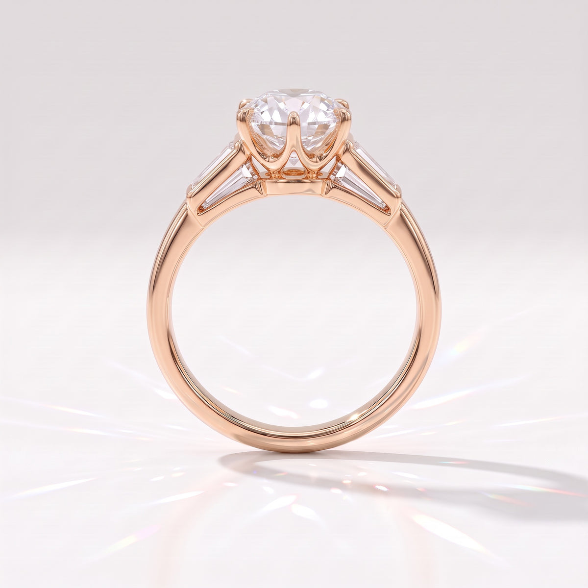 Old mine round lab-grown diamond vintage three-stone engagement ring with tapered baguettes in 14K (585) rose gold, profile view showing the six-claw crown basket 