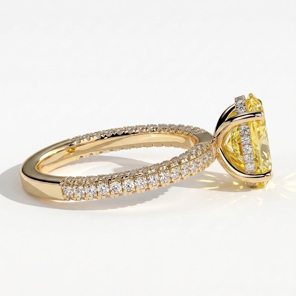 Fancy Vivid Yellow oval lab-grown diamond engagement ring with triple pavé band and hidden halo in 18K (750) yellow gold, detail view of the triple pavé band 