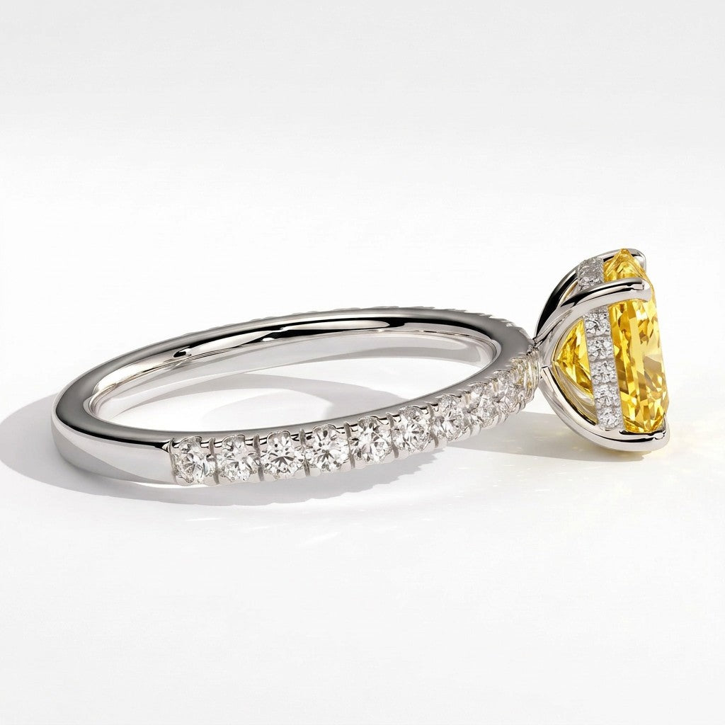 Fancy Vivid Yellow elongated cushion lab-grown diamond engagement ring with hidden halo and pavé band in 14K (585) white gold, detail view of the pavé band 