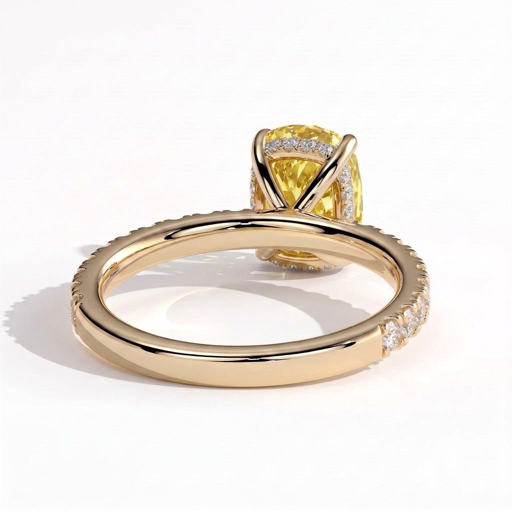 Fancy Vivid Yellow elongated cushion lab-grown diamond engagement ring with hidden halo and pavé band in 14K (585) yellow gold, on white background 