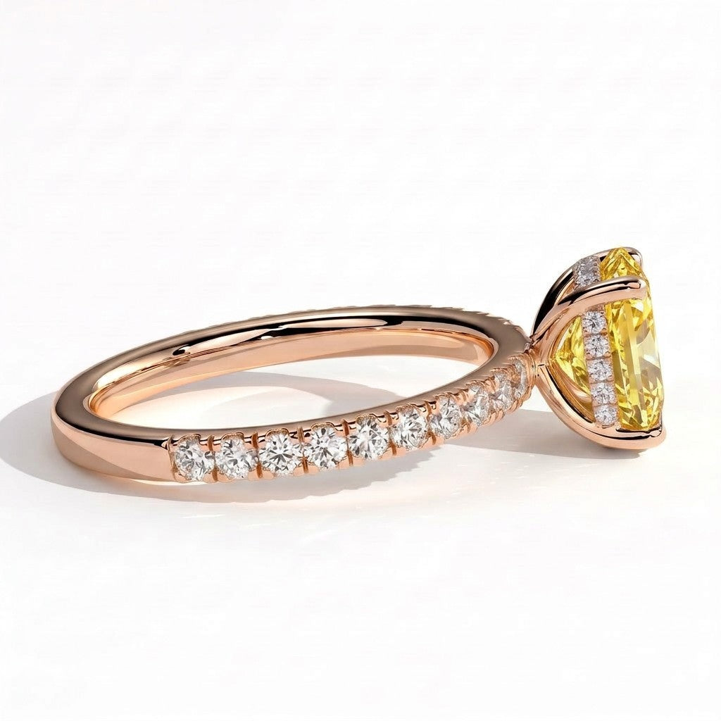 Fancy Vivid Yellow elongated cushion lab-grown diamond engagement ring with hidden halo and pavé band in 18K (750) rose gold, detail view of the pavé band 