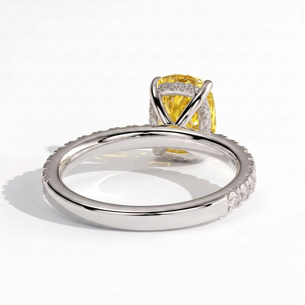 Fancy Vivid Yellow elongated cushion lab-grown diamond engagement ring with hidden halo and pavé band in 18K (750) white gold, on white background 