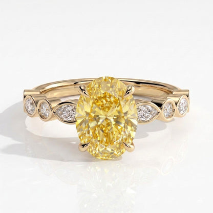 Fancy Vivid Yellow oval lab-grown diamond engagement ring with bezel-set pear and round shoulder accents in 14K (585) yellow gold, front view 