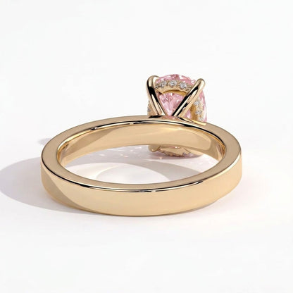 Fancy Vivid Pink elongated cushion lab-grown diamond engagement ring with flat cigar band and hidden halo in 14K (585) yellow gold, on white background 
