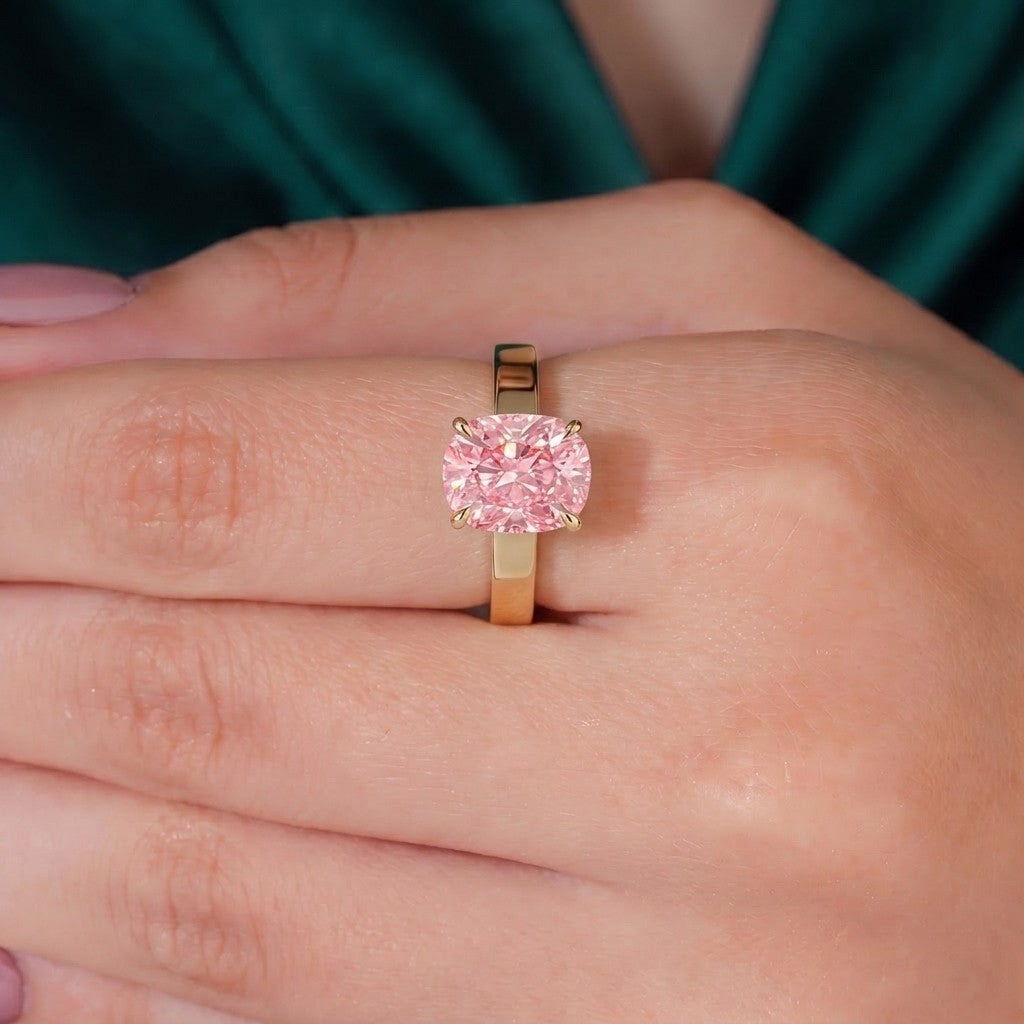 Fancy Vivid Pink elongated cushion lab-grown diamond engagement ring with flat cigar band and hidden halo in 950 platinum, three-quarter view 