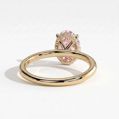 Fancy Vivid Pink oval lab-grown diamond engagement ring with wrap-around hidden halo in 14K (585) yellow gold, on white background 