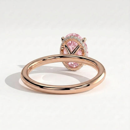Fancy Vivid Pink oval lab-grown diamond engagement ring with wrap-around hidden halo in 18K (750) rose gold, on white background 
