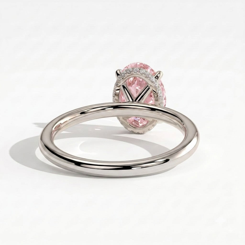 Fancy Vivid Pink oval lab-grown diamond engagement ring with wrap-around hidden halo in 18K (750) white gold, on white background 