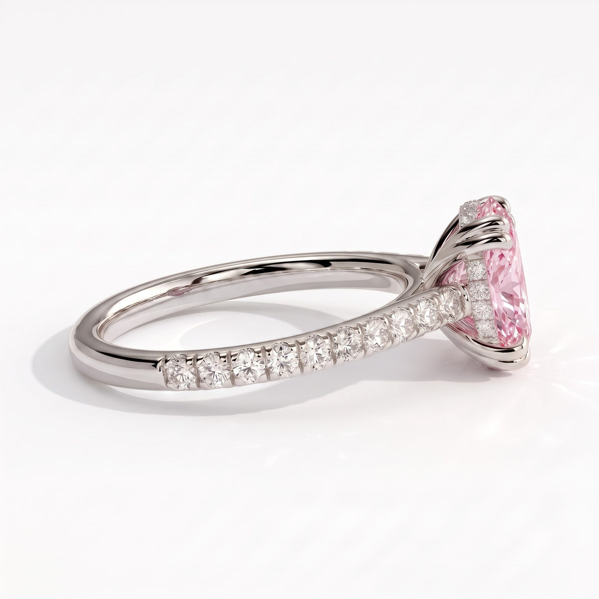 Fancy Vivid Pink oval lab-grown diamond double claw engagement ring with pavé band and hidden halo in 14K (585) white gold, detail view of the pavé band 