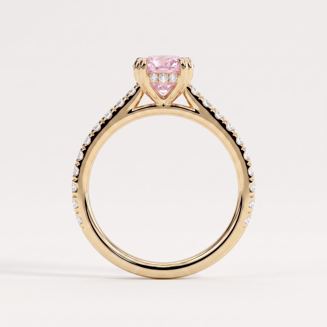 Fancy Vivid Pink oval lab-grown diamond double claw engagement ring with pavé band and hidden halo in 14K (585) yellow gold, side profile showing the cathedral setting 