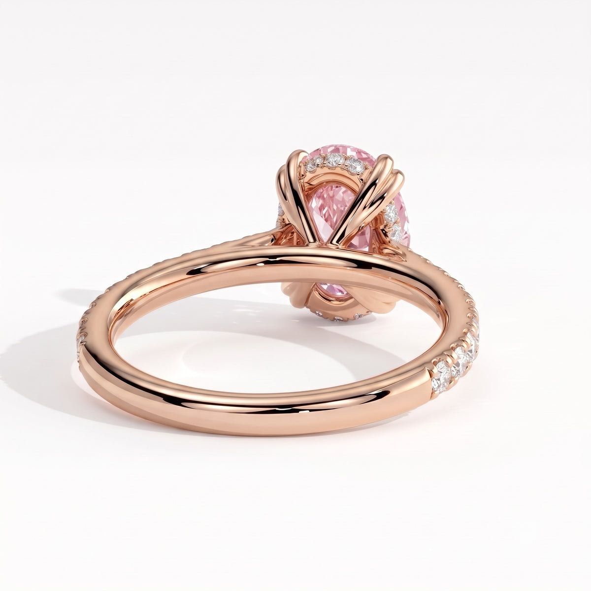 Fancy Vivid Pink oval lab-grown diamond double claw engagement ring with pavé band and hidden halo in 18K (750) rose gold, back view showing the hidden halo 