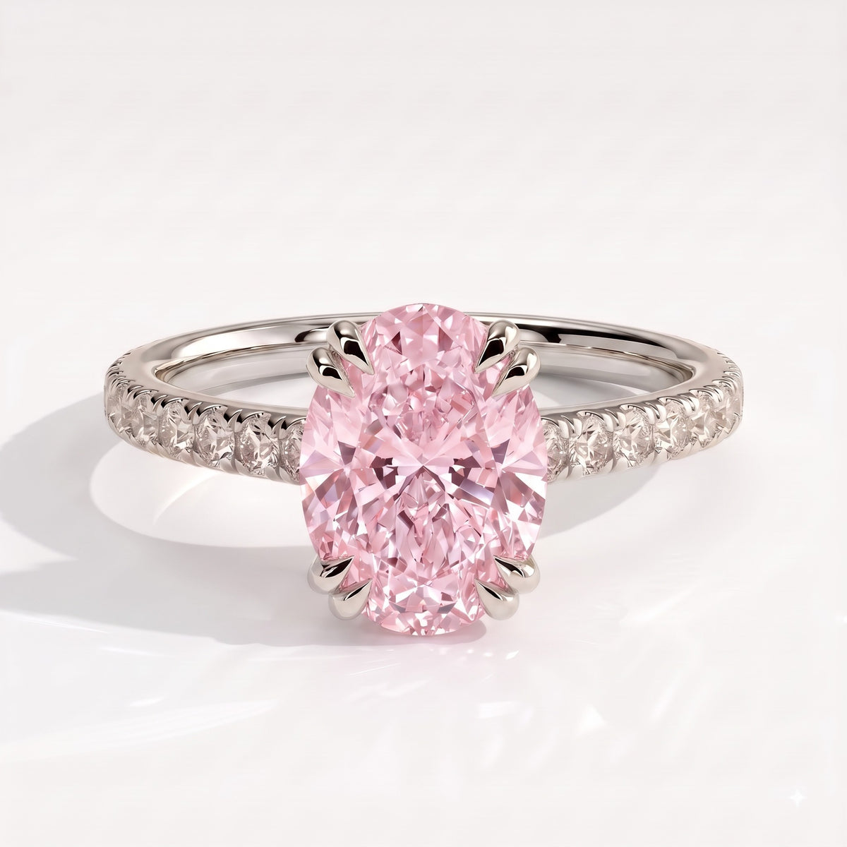 Fancy Vivid Pink oval lab-grown diamond double claw engagement ring with pavé band and hidden halo in 950 platinum, front view 