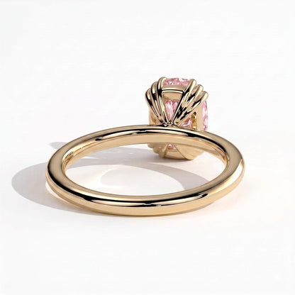 Fancy Vivid Pink elongated cushion lab-grown diamond solitaire engagement ring with triple claw prongs in 14K (585) yellow gold, on white background 