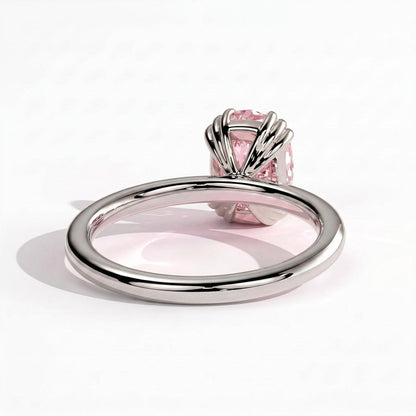 Fancy Vivid Pink elongated cushion lab-grown diamond solitaire engagement ring with triple claw prongs in 950 platinum, detail view of the triple claws 