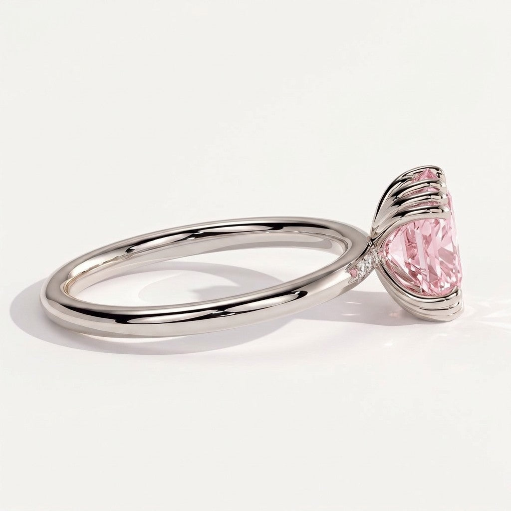 Fancy Vivid Pink elongated cushion lab-grown diamond solitaire engagement ring with triple claw prongs in 950 platinum, on white background 