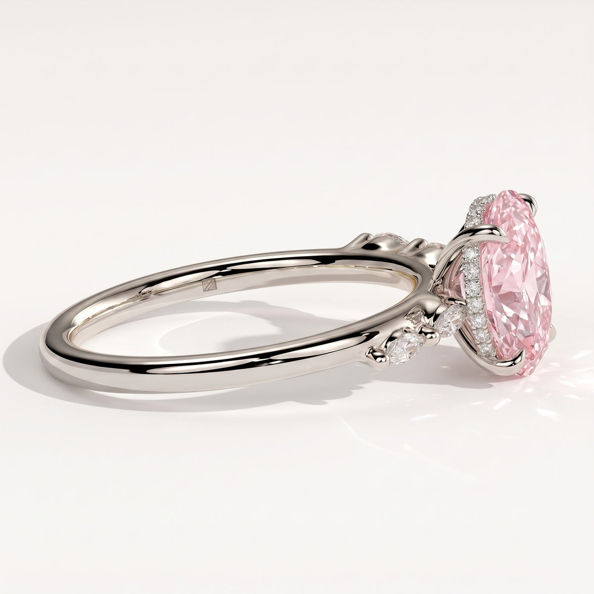 Fancy Vivid Pink oval lab-grown diamond hidden halo engagement ring with marquise accents in 18K (750) white gold, detail view of the marquise accents 
