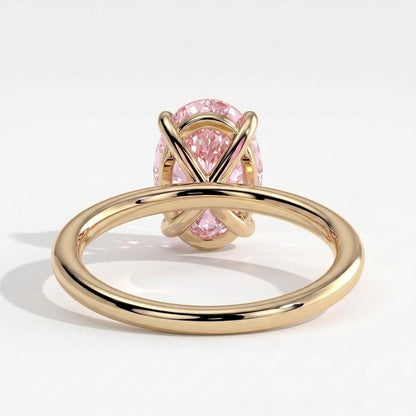 Fancy Vivid Pink oval lab-grown diamond solitaire engagement ring in 14K (585) yellow gold, on white background 