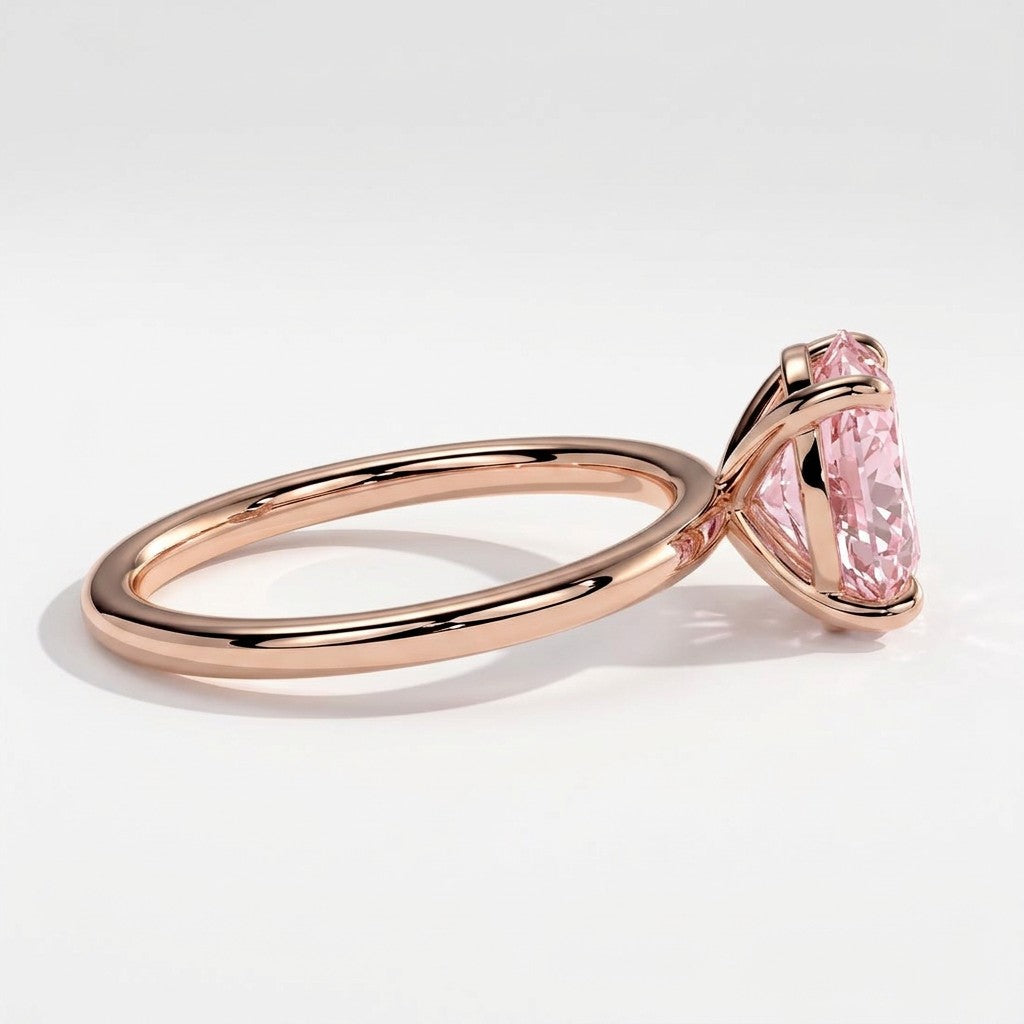 Fancy Vivid Pink oval lab-grown diamond solitaire engagement ring in 18K (750) rose gold, detail view of the four-claw setting 