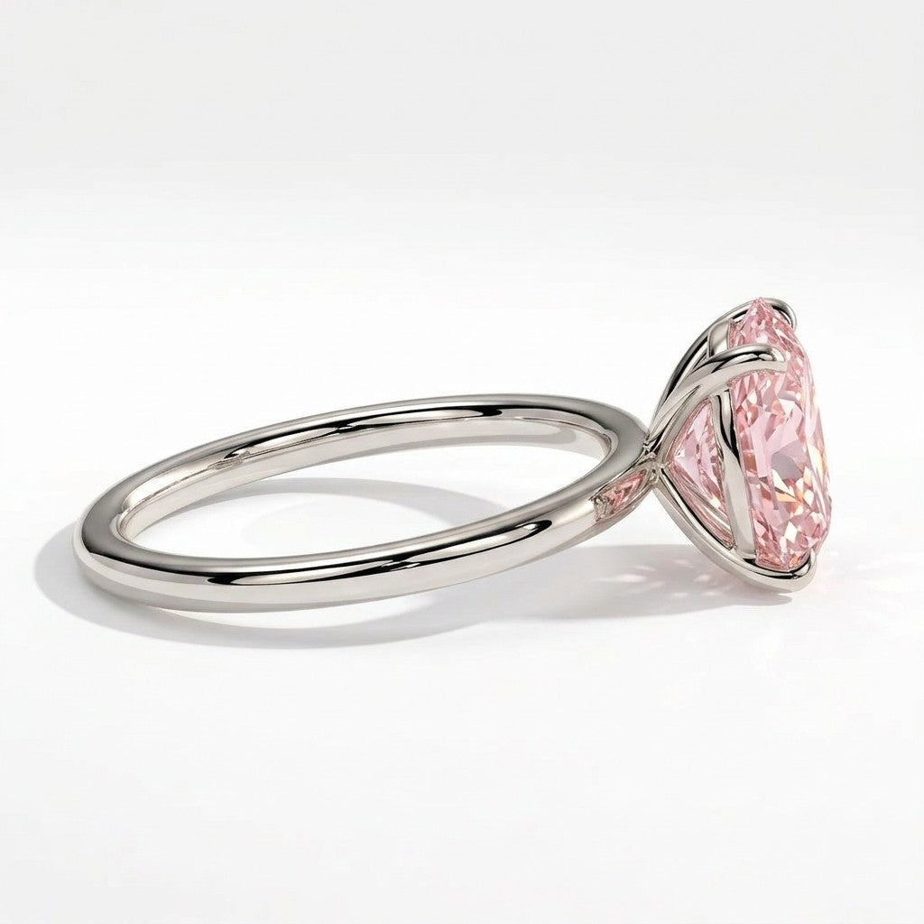 Fancy Vivid Pink oval lab-grown diamond solitaire engagement ring in 18K (750) white gold, detail view of the four-claw setting 
