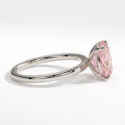 Fancy Vivid Pink oval lab-grown diamond solitaire engagement ring in 950 platinum, detail view of the four-claw setting 