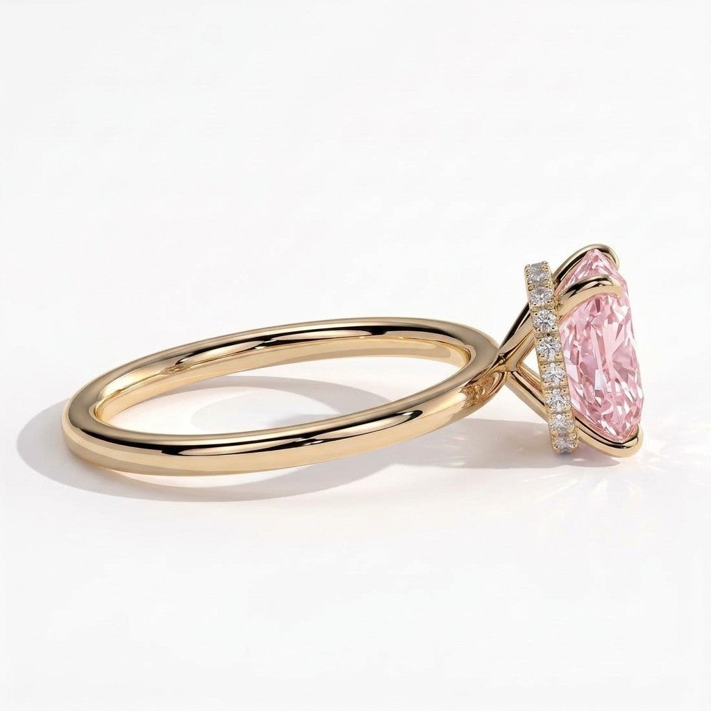 Fancy Vivid Pink elongated cushion lab-grown diamond engagement ring with wrap-around hidden halo in 14K (585) yellow gold, detail view of the wrap-around hidden halo 
