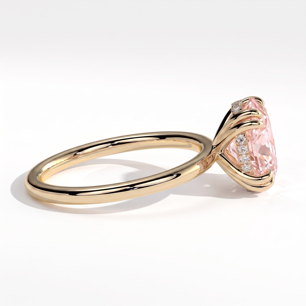Fancy Vivid Pink oval lab-grown diamond double claw engagement ring with hidden halo in 14K (585) yellow gold, detail view of the double claws 