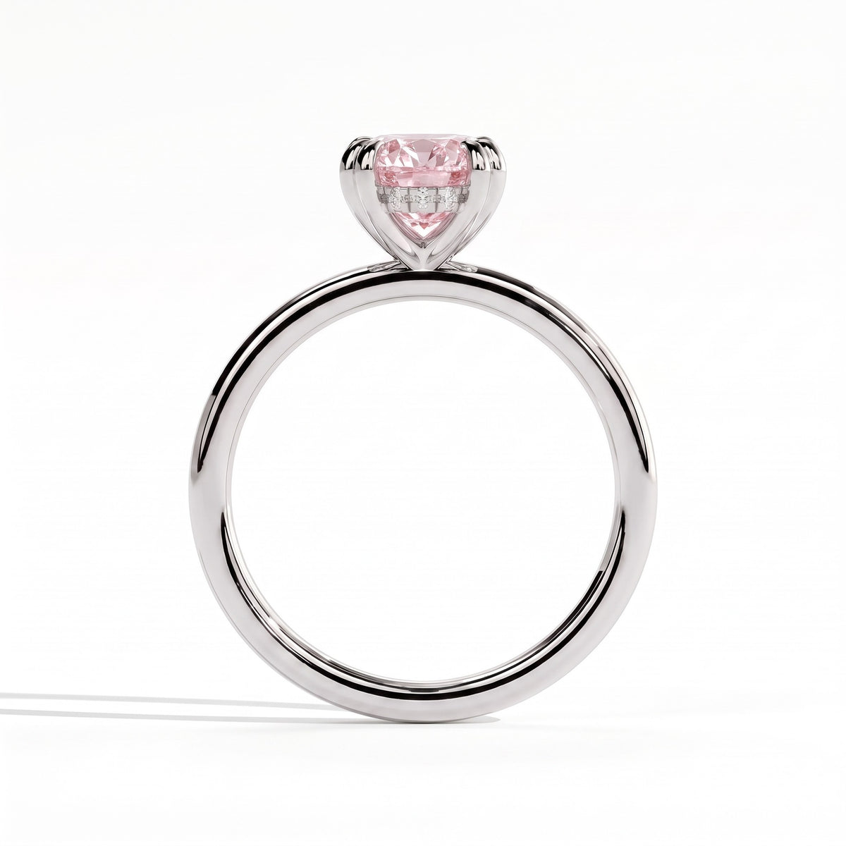 Fancy Vivid Pink oval lab-grown diamond double claw engagement ring with hidden halo in 950 platinum, side profile showing the hidden halo 