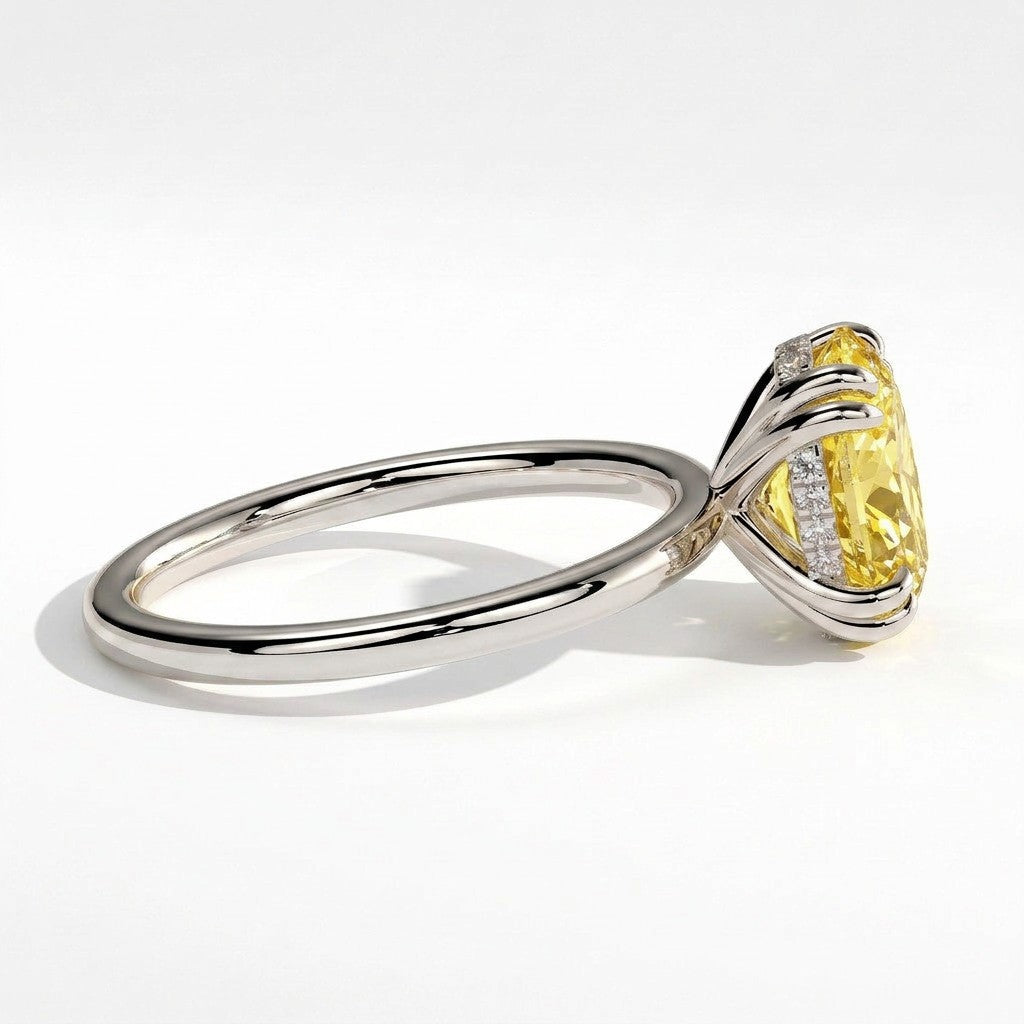 Fancy Vivid Yellow oval lab-grown diamond double claw engagement ring with hidden halo in 950 platinum, detail view of the double claws 