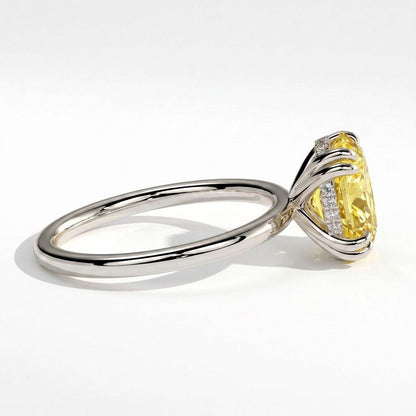 Fancy Vivid Yellow oval lab-grown diamond double claw engagement ring with hidden halo in 950 platinum, detail view of the double claws 