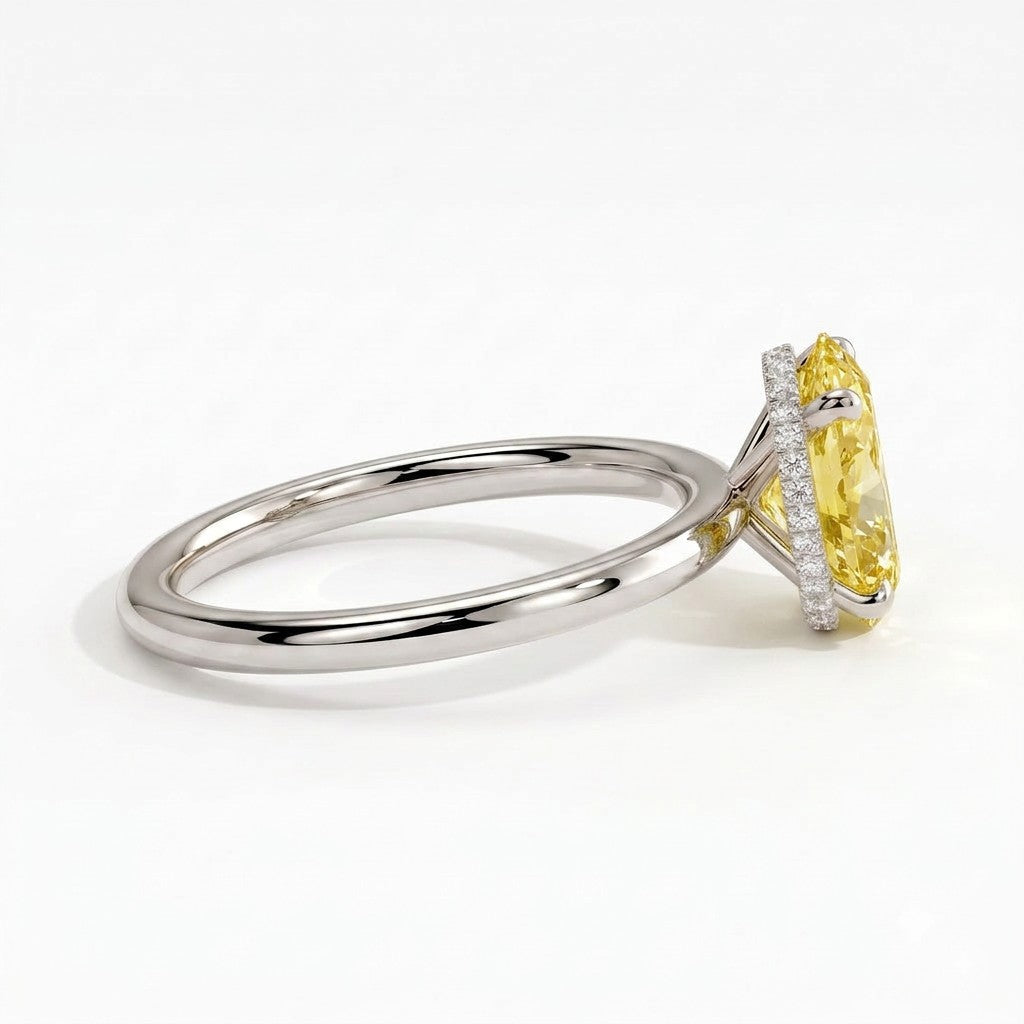 Fancy Vivid Yellow oval lab-grown diamond engagement ring with wrap-around hidden halo in 14K (585) white gold, detail view of the wrap-around hidden halo 