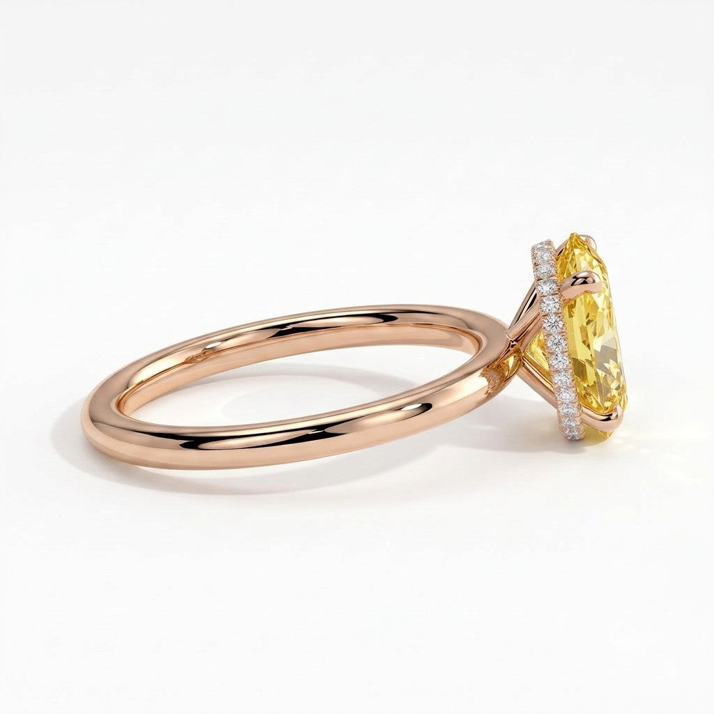 Fancy Vivid Yellow oval lab-grown diamond engagement ring with wrap-around hidden halo in 18K (750) rose gold, detail view of the wrap-around hidden halo 