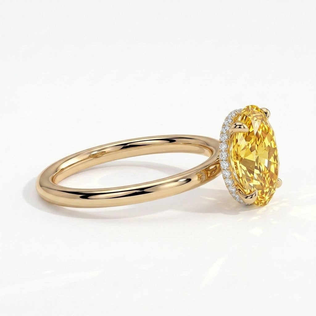 Fancy Vivid Yellow oval lab-grown diamond engagement ring with wrap-around hidden halo in 18K (750) yellow gold, detail view of the wrap-around hidden halo 