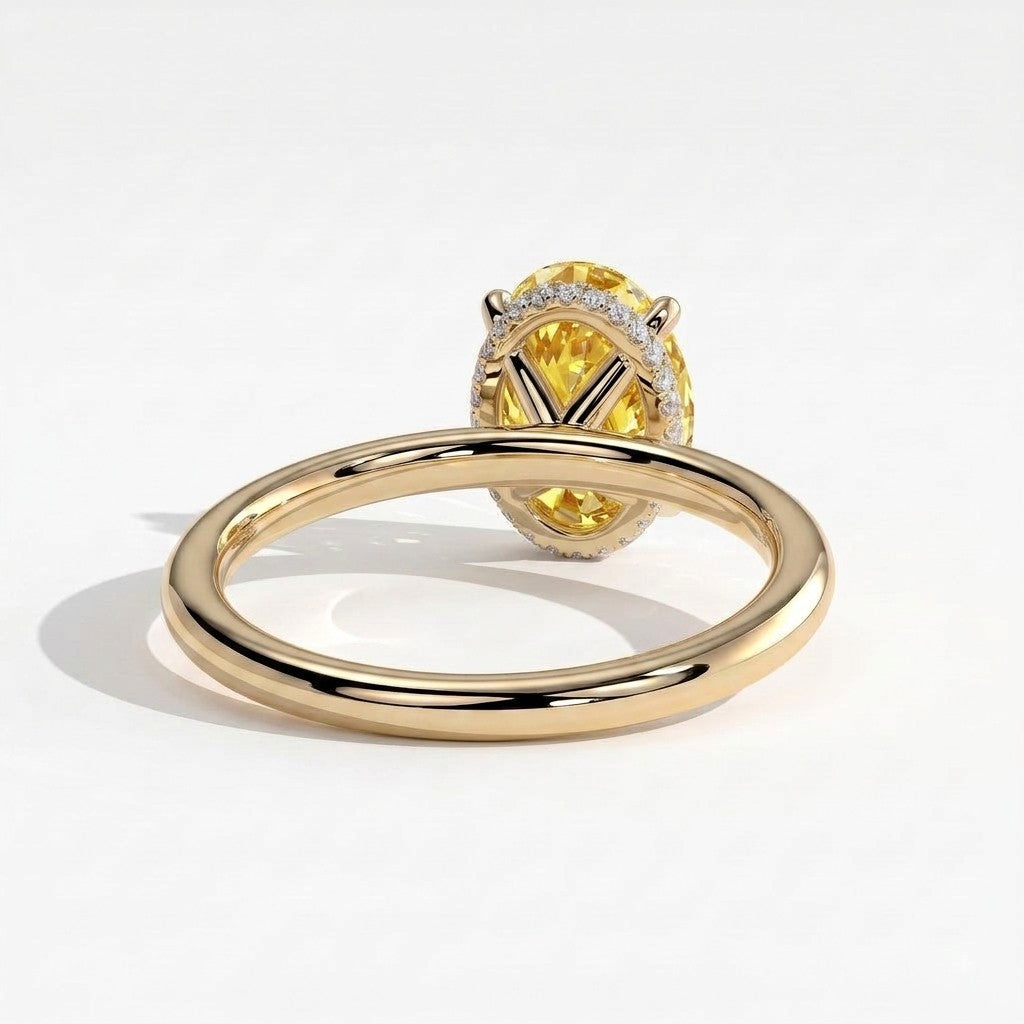 Fancy Vivid Yellow oval lab-grown diamond engagement ring with wrap-around hidden halo in 18K (750) yellow gold, on white background 