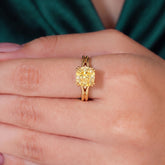 Fancy Vivid Yellow cushion lab-grown diamond split shank ring in 18K (750) white gold, worn on finger, on-hand top view 