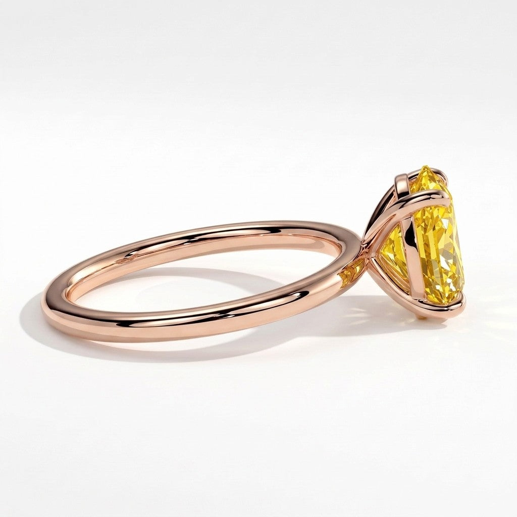 Fancy Vivid Yellow oval lab-grown diamond solitaire engagement ring in 14K (585) rose gold, detail view of the four-claw setting 