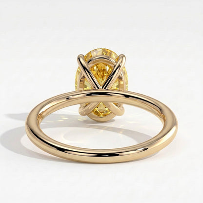 Fancy Vivid Yellow oval lab-grown diamond solitaire engagement ring in 14K (585) yellow gold, on white background 