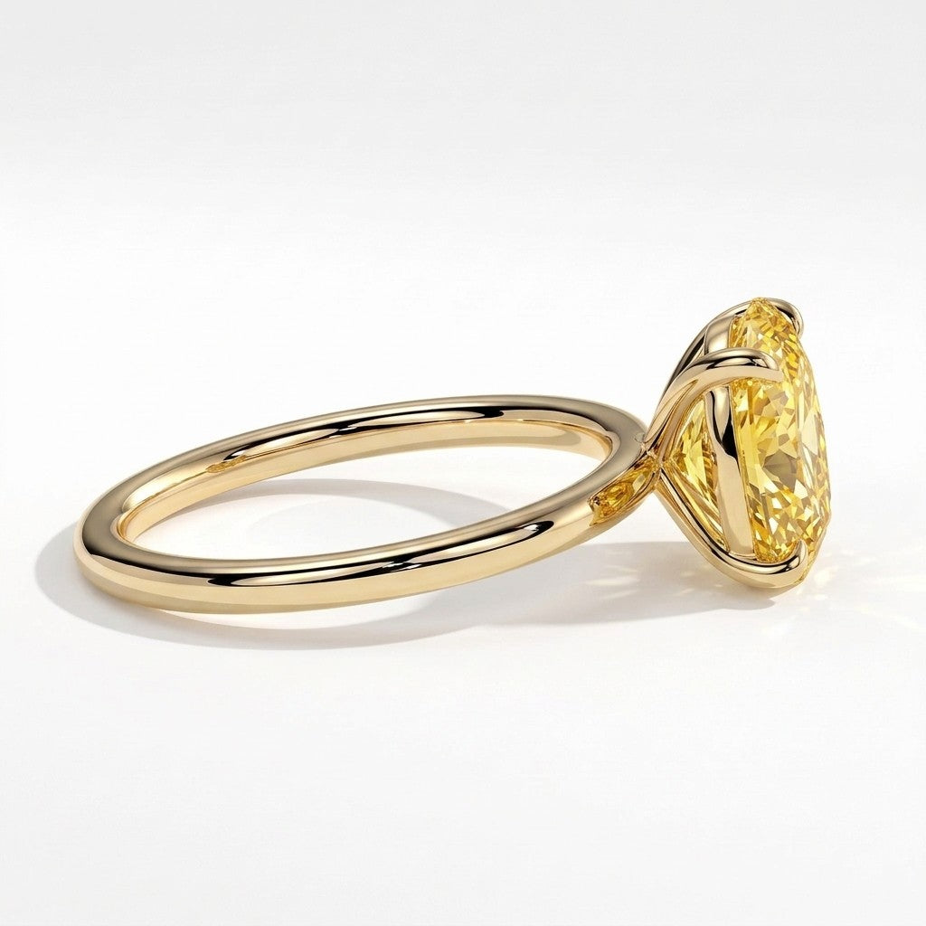 Fancy Vivid Yellow oval lab-grown diamond solitaire engagement ring in 18K (750) yellow gold, detail view of the four-claw setting 