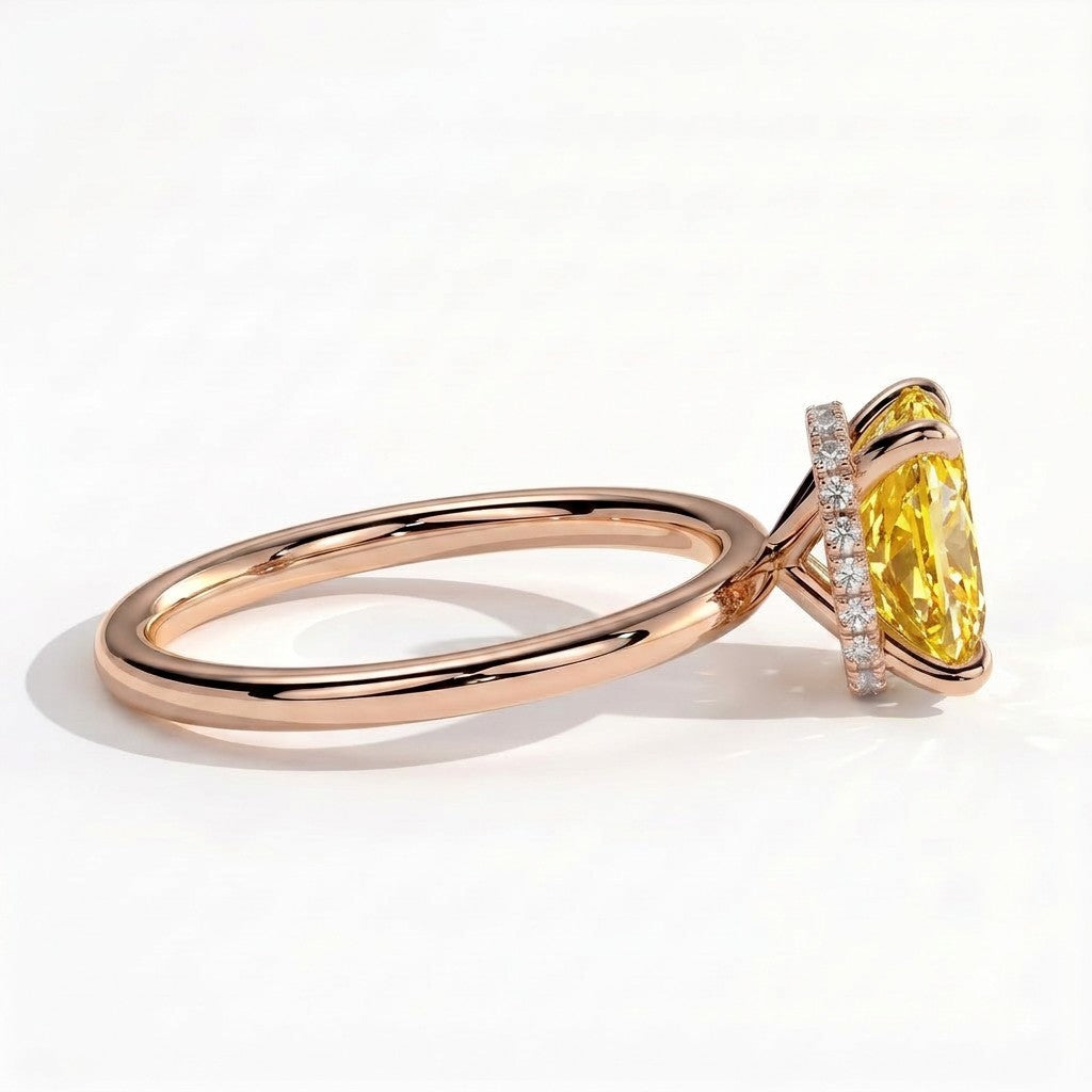 Fancy Vivid Yellow elongated cushion lab-grown diamond engagement ring with wrap-around hidden halo in 14K (585) rose gold, detail view of the wrap-around hidden halo 